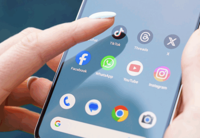 A women holding a smart phone tapping on TikTok